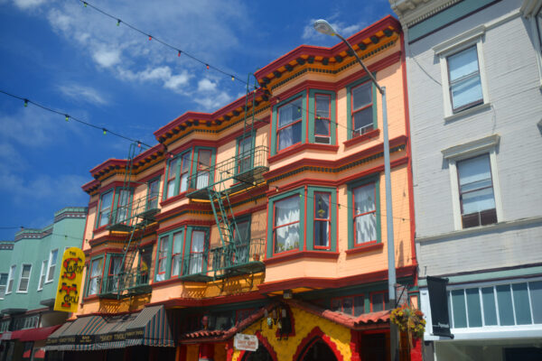 The Savoy Tivoli With Strings Of Lights Over Grant Avenue From Colorful Terraced Houses In San Francisco, California