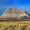 A Very Colorful Blue Badlands Butte Stands Over The Golden Plains Of Petrified Forest National Park, Arizona