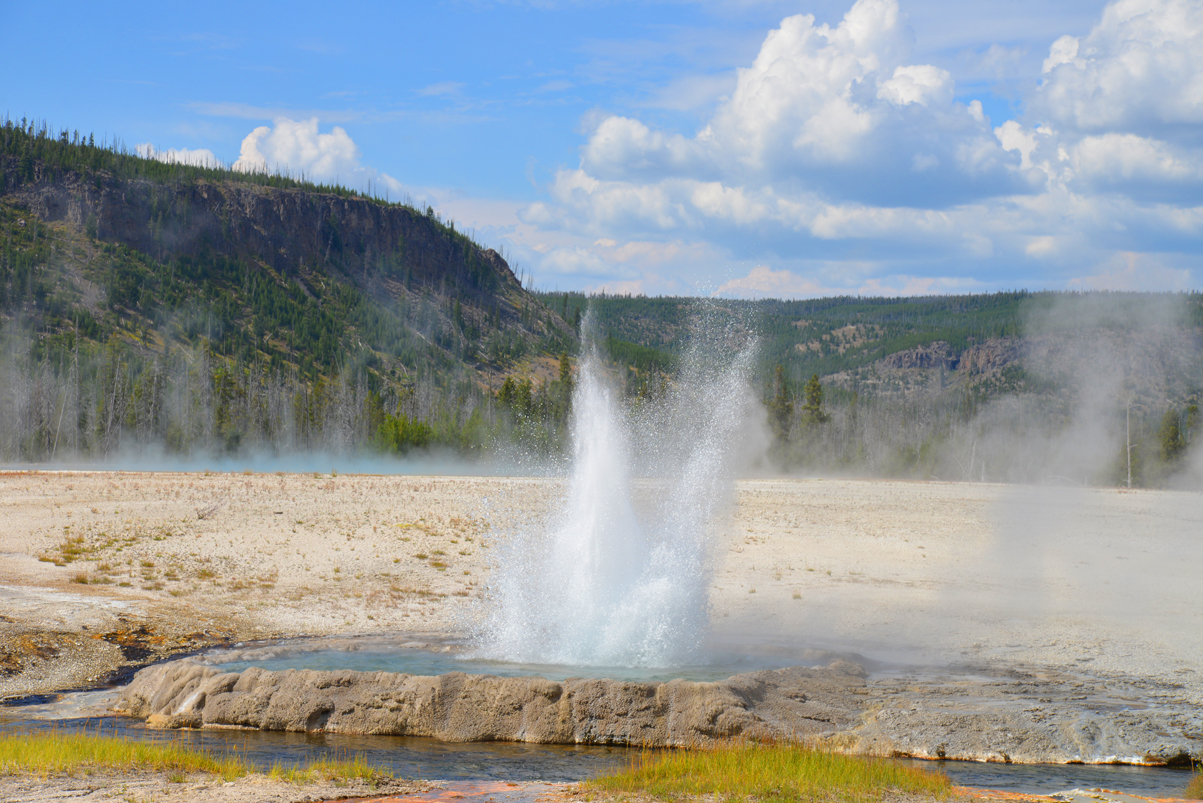 Cliff Geyser Erupts From A Pool Above Iron Spring Creek In Black Sand