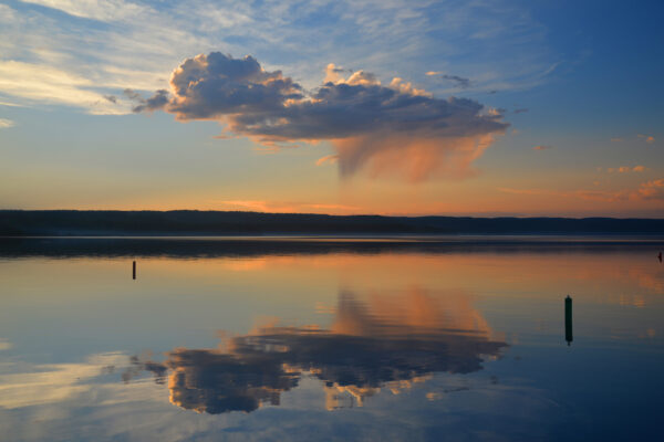 Reddened Rain Curtains Drop From A High Cloud Reflected Over An Unusually Calm Yellowstone Lake In Yellowstone National Park, Wyoming