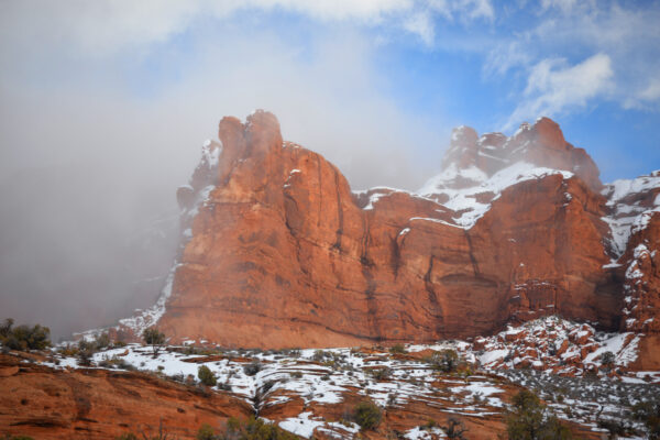 A Thick Fog Bank Begins To Envelop The Snow Covered Red Cliffs At The Very Highest Altitude Regions Of Arches National Park, Utah