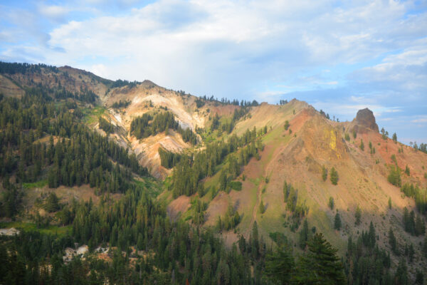 A Colorfully Streaked Ridge With A Large Volcanic Plug Is Being Slowly Recolonized By Vegetation In Lassen Volcanic National Park, California